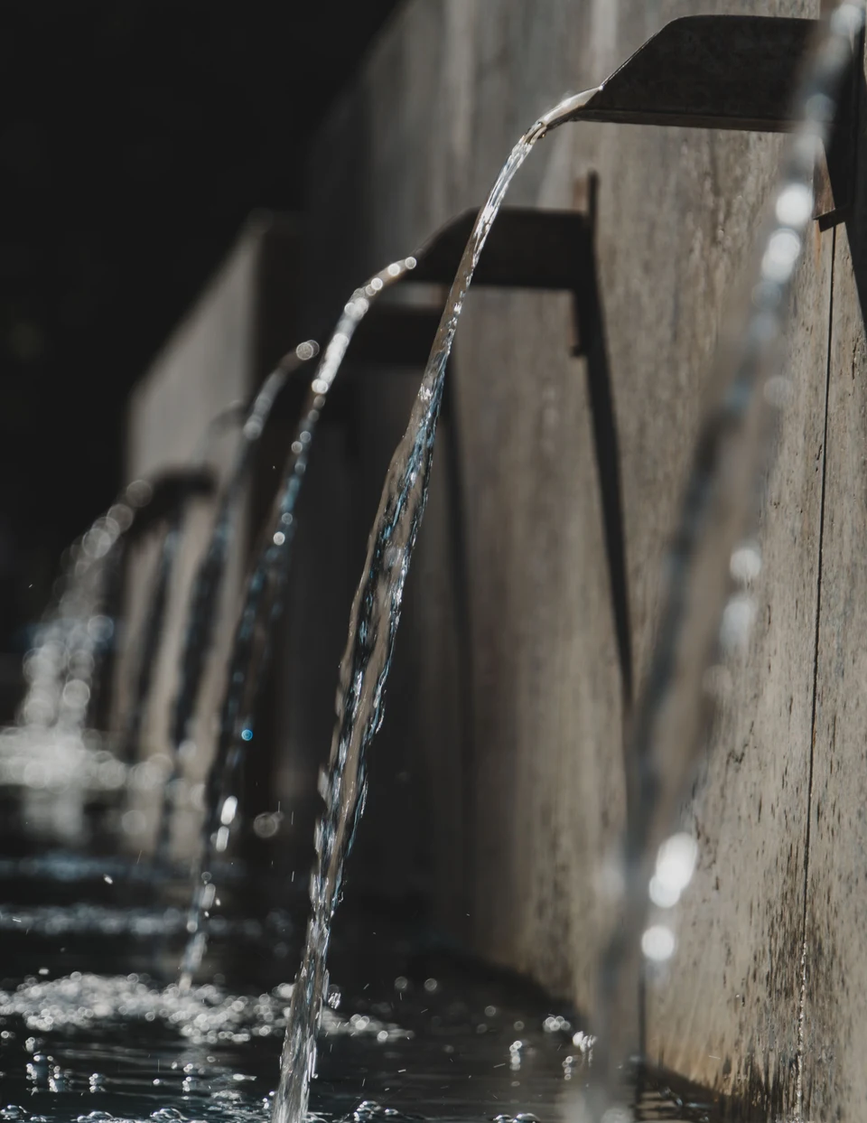 Treated water discharging from a pipe outlet into an open channel